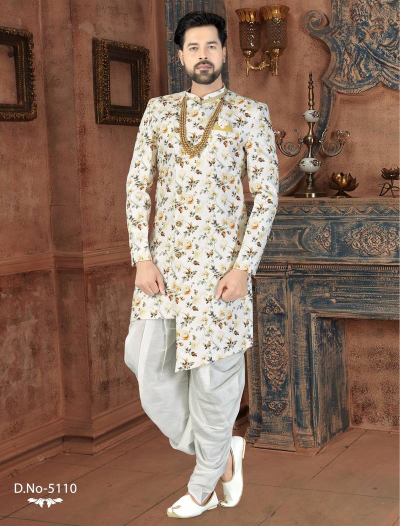 Off white floral sherwani with gold necklace, matching pocket square, and white trousers.