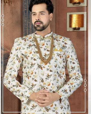 Off white floral sherwani with gold necklace, matching pocket square, and white trousers. 2
