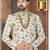 Off white floral sherwani with gold necklace, matching pocket square, and white trousers.