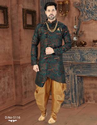 Dark blue sherwani with teal-rust botanical patterns, pearl accessories, and gold dhoti-style trousers. 1