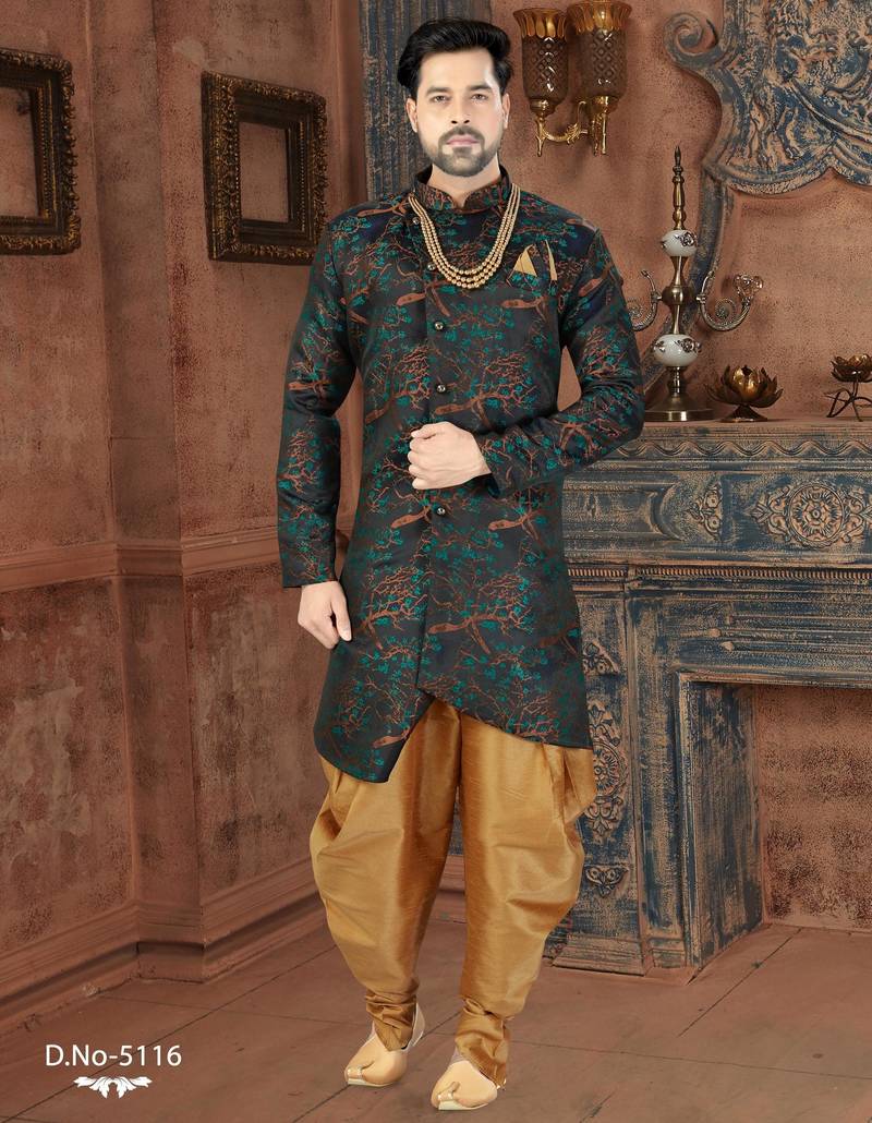 Dark blue sherwani with teal-rust botanical patterns, pearl accessories, and gold dhoti-style trousers.