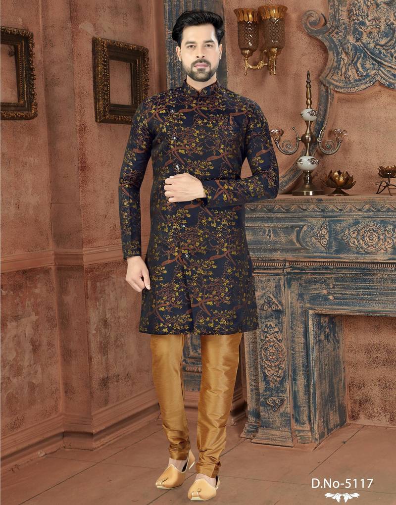 Dark blue sherwani with gold-rust botanical patterns and gold trousers.