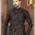 Dark blue sherwani with gold-rust botanical patterns and gold trousers.