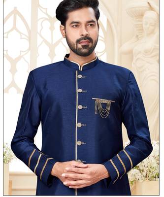Beige sherwani with striped cuffs, chain pocket detail, and brown trousers. 2