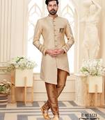 Beige sherwani with striped cuffs, chain pocket, and brown trousers.