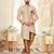 Beige sherwani with striped cuffs, chain pocket, and brown trousers.