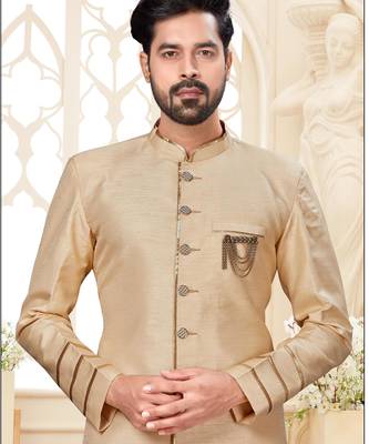 Beige sherwani with striped cuffs, chain pocket, and brown trousers. 2