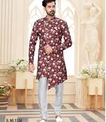 Maroon floral sherwani with asymmetrical front, white pocket square, and white trousers.