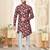 Maroon floral sherwani with asymmetrical front, white pocket square, and white trousers.