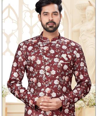 Maroon floral sherwani with asymmetrical front, white pocket square, and white trousers. 2