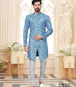 Blue-and-white patterned sherwani with asymmetrical front, matching pocket square, and white trousers.