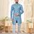 Blue-and-white patterned sherwani with asymmetrical front, matching pocket square, and white trousers.