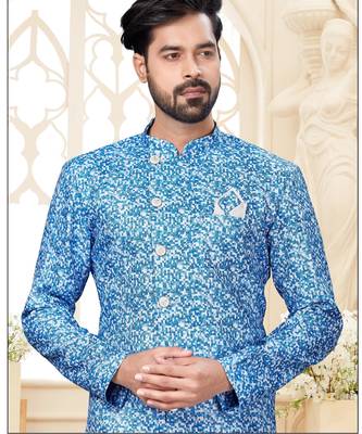 Blue-and-white patterned sherwani with asymmetrical front, matching pocket square, and white trousers. 2