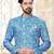 Blue-and-white patterned sherwani with asymmetrical front, matching pocket square, and white trousers.