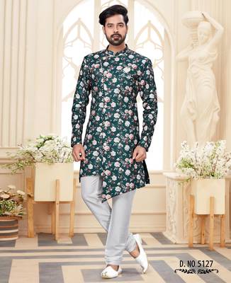 Deep-teal floral sherwani with asymmetrical front, ivory pocket square, and white trousers. 1