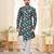 Deep-teal floral sherwani with asymmetrical front, ivory pocket square, and white trousers.