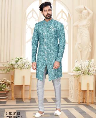 Teal-and-white patterned sherwani with asymmetrical front, matching pocket square, and white trousers. 1