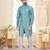 Teal-and-white patterned sherwani with asymmetrical front, matching pocket square, and white trousers.