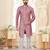 Dark-maroon-and-white patterned sherwani with asymmetrical front, with white trousers.