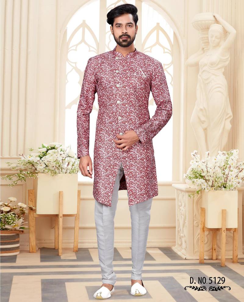 Dark-maroon-and-white patterned sherwani with asymmetrical front, with white trousers.