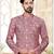Dark-maroon-and-white patterned sherwani with asymmetrical front, with white trousers.