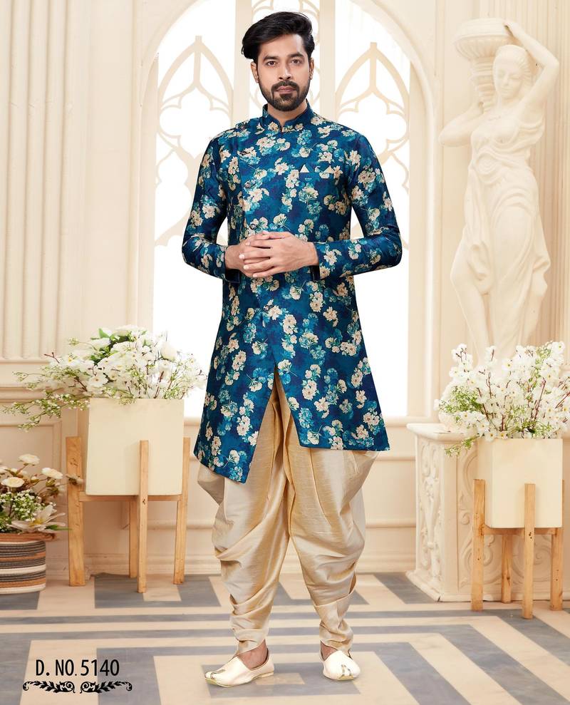 Teal floral sherwani with matching pocket square and cream dhoti-style trousers.
