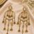 Gold plated metallic kundan tassel earrings