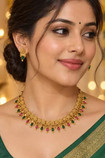 traditional gold-tone necklace with ruby and green stone drops