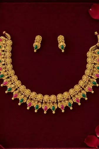 traditional gold-tone necklace with ruby and green stone drops