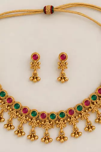 antique gold-tone necklace set with ruby and green stones