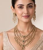 Gold plated emerald green kundan layered necklace set with maang tikka