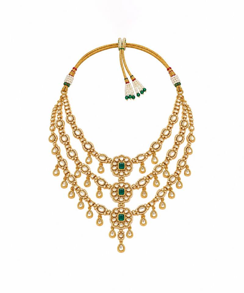Gold plated emerald green kundan layered necklace set with maang tikka