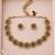 Antique gold-tone floral bead necklace set with red and green accents