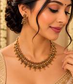 Antique gold-tone floral leaf necklace set with dangling charms