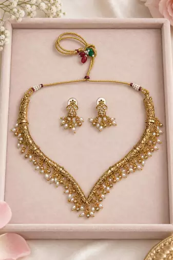 Antique gold-tone v-shaped necklace set with pearl dangles