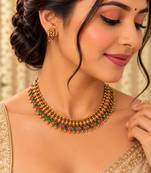 Gold-tone necklace set with ruby and emerald stones and beaded links