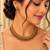 Gold-tone necklace set with ruby and emerald stones and beaded links