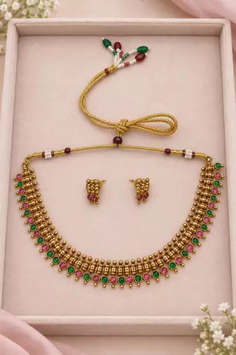 Gold-tone necklace set with ruby and emerald stones and beaded links