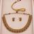Gold-tone necklace set with ruby and emerald stones and beaded links