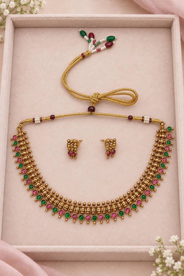 Gold-tone necklace set with ruby and emerald stones and beaded links