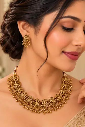 Antique gold-tone temple necklace set with traditional motif earrings