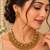 Antique gold-tone temple necklace set with traditional motif earrings