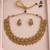 Antique gold-tone temple necklace set with traditional motif earrings