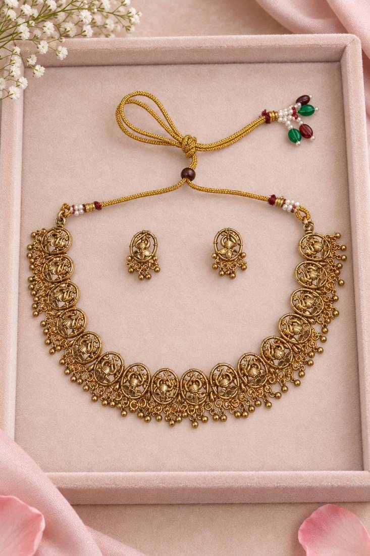 Antique gold-tone temple necklace set with traditional motif earrings