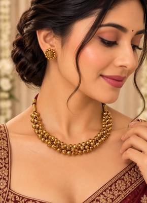 Traditional gold-tone beaded necklace set with matching stud earrings 1