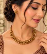 Traditional gold-tone beaded necklace set with matching stud earrings