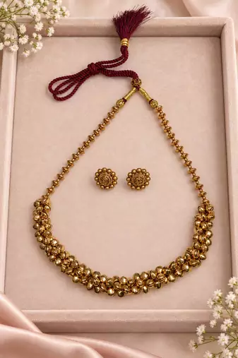 Traditional gold-tone beaded necklace set with matching stud earrings
