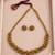 Traditional gold-tone beaded necklace set with matching stud earrings