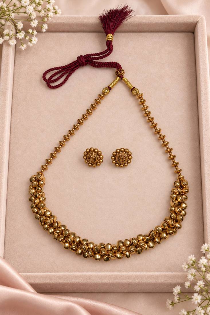 Traditional gold-tone beaded necklace set with matching stud earrings