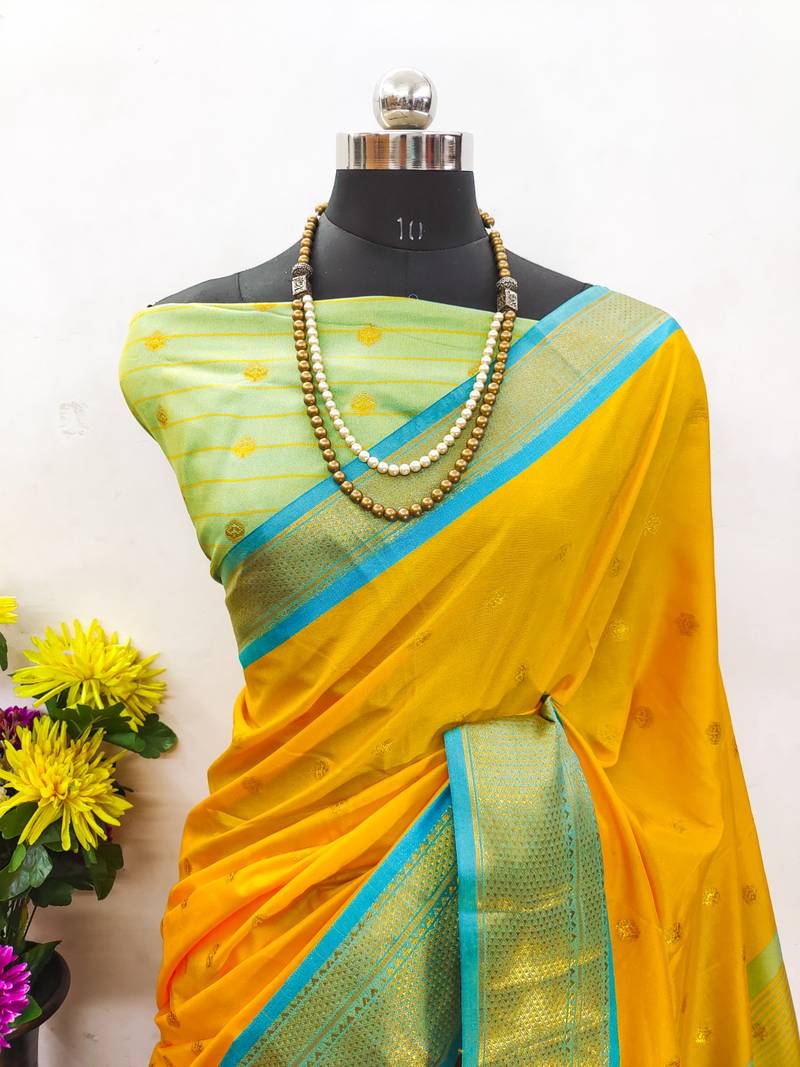 Golden yellow zari woven silk blend traditional saree with blouse